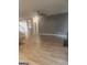 Cozy living room with hardwood floors, a modern accent wall, and ample natural light at 1049 Homer Ln, Stockbridge, GA 30281