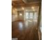 Bright and airy living room featuring hardwood floors, decorative molding, and large windows at 1049 Homer Ln, Stockbridge, GA 30281