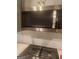 Close-up of a modern stainless steel Whirlpool microwave with white subway tile backsplash at 1049 Homer Ln, Stockbridge, GA 30281