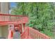 Spacious back deck and stairs overlooking a lush green space at 165 Hidden Lake Dr, Fayetteville, GA 30215