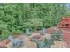 The backyard features a patio with Adirondack chairs, fire pit, and lush trees at 165 Hidden Lake Dr, Fayetteville, GA 30215