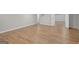 Spacious basement featuring attractive wood flooring, neutral paint, and ample lighting throughout the room at 165 Hidden Lake Dr, Fayetteville, GA 30215