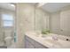 Bathroom featuring dual sinks, modern fixtures, a framed mirror, and wall decor at 165 Hidden Lake Dr, Fayetteville, GA 30215