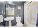 Bathroom featuring blue wallpaper, a vessel sink, and a shower and tub combo at 165 Hidden Lake Dr, Fayetteville, GA 30215