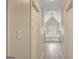 Hallway view into the spacious primary bathroom, featuring a large tub and lots of natural light at 165 Hidden Lake Dr, Fayetteville, GA 30215