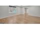 Bedroom with a large window, neutral paint, and hardwood floors at 165 Hidden Lake Dr, Fayetteville, GA 30215