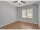 Bright bedroom featuring a ceiling fan, hardwood floors, and a window with natural light at 165 Hidden Lake Dr, Fayetteville, GA 30215