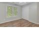 Neutral bedroom with hardwood floors, a window, and closet space at 165 Hidden Lake Dr, Fayetteville, GA 30215