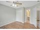Bedroom with hardwood floors, closet, and an adjoining bathroom with neutral paint and design at 165 Hidden Lake Dr, Fayetteville, GA 30215