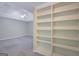 Spacious bonus room with bright light, plush carpet, neutral walls and built-in shelving at 165 Hidden Lake Dr, Fayetteville, GA 30215