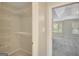 Walk-in closet featuring shelving on walls and carpeted flooring, offering ample storage space at 165 Hidden Lake Dr, Fayetteville, GA 30215