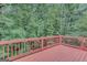 Outdoor deck with wood railing offers a peaceful treetop view at 165 Hidden Lake Dr, Fayetteville, GA 30215