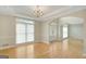 Bright dining room featuring hardwood floors, large windows, and elegant french doors at 165 Hidden Lake Dr, Fayetteville, GA 30215