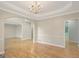 Elegant dining room with hardwood floors, chair rail, and decorative chandelier at 165 Hidden Lake Dr, Fayetteville, GA 30215