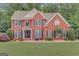 Charming two-story red brick home with black shutters and manicured lawn at 165 Hidden Lake Dr, Fayetteville, GA 30215