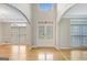 Grand foyer with high ceilings, hardwood floors, and elegant glass-paned doors at 165 Hidden Lake Dr, Fayetteville, GA 30215