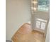 Two-story foyer featuring hardwood floors, a chandelier, and a front door with glass detailing at 165 Hidden Lake Dr, Fayetteville, GA 30215