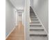 Hallway with hardwood floors leading to carpeted stairs and multiple rooms at 165 Hidden Lake Dr, Fayetteville, GA 30215