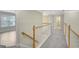 Upstairs hallway features carpet, and light wood railing, creating a bright and inviting space at 165 Hidden Lake Dr, Fayetteville, GA 30215