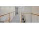 Second floor hallway with wood railing, staircase, and neutral walls, featuring lots of natural light at 165 Hidden Lake Dr, Fayetteville, GA 30215