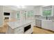 Kitchen features a granite island, stainless appliances and is open to a living room with a fireplace at 165 Hidden Lake Dr, Fayetteville, GA 30215