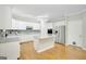Bright eat-in kitchen with stainless appliances, granite counters, white cabinets, and an island at 165 Hidden Lake Dr, Fayetteville, GA 30215