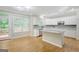 Charming kitchen with granite countertops, white cabinets, stainless appliances, and eat-in island at 165 Hidden Lake Dr, Fayetteville, GA 30215