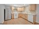 Updated kitchen featuring stainless steel appliances, wood cabinets, and a tile backsplash at 165 Hidden Lake Dr, Fayetteville, GA 30215