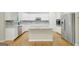 Modern kitchen features a large island, stainless appliances, white cabinets, and granite countertops at 165 Hidden Lake Dr, Fayetteville, GA 30215
