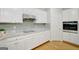 Well-equipped kitchen featuring granite countertops, custom white cabinetry and stainless appliances at 165 Hidden Lake Dr, Fayetteville, GA 30215