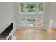 Bright living room with hardwood floors and large windows overlooking the lush greenery outside at 165 Hidden Lake Dr, Fayetteville, GA 30215