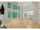 Open living room featuring hardwood floors, large windows, and an open concept design at 165 Hidden Lake Dr, Fayetteville, GA 30215