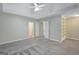Large main bedroom with neutral walls, plush carpet, tray ceiling, and multiple closets at 165 Hidden Lake Dr, Fayetteville, GA 30215