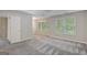 Spacious main bedroom with neutral walls, plush carpet, large windows, and a large closet at 165 Hidden Lake Dr, Fayetteville, GA 30215