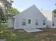 View of backyard with concrete patio, vinyl siding and lush green grass at 3075 Lakeside Cir, Covington, GA 30016
