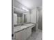Bathroom featuring white cabinets, granite counters, a large mirror, and tile floors and shower at 3075 Lakeside Cir, Covington, GA 30016