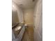 Well-lit bathroom with a granite countertop, a toilet, and a bathtub with white tile surround at 921 Winding Down Way, Grayson, GA 30017