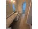 Large granite countertop vanity and walk-in closet in bathroom at 921 Winding Down Way, Grayson, GA 30017