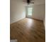 Bright bedroom featuring hardwood floors, ceiling fan, and window allowing ample natural light at 921 Winding Down Way, Grayson, GA 30017