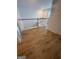 A hallway with wood floors, a staircase and white railings and trim at 921 Winding Down Way, Grayson, GA 30017