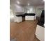 A well-lit kitchen with white cabinets, black countertops, and stainless steel appliances at 921 Winding Down Way, Grayson, GA 30017
