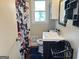 Cozy bathroom featuring a modern vanity, dark wood laminate flooring, and a patterned shower curtain at 503 Roy Huie Rd, Riverdale, GA 30274