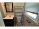 Bathroom featuring a vanity, toilet with rack, framed mirror, and shower with sliding glass doors at 503 Roy Huie Rd, Riverdale, GA 30274