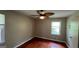 Bedroom featuring gleaming hardwood floors, a ceiling fan and neutral walls with natural light at 503 Roy Huie Rd, Riverdale, GA 30274