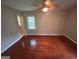 Bedroom features hardwood floors, a ceiling fan, and a window with natural light at 503 Roy Huie Rd, Riverdale, GA 30274