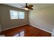 Bedroom features a ceiling fan, natural light, and beautiful hardwood floors at 503 Roy Huie Rd, Riverdale, GA 30274