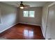 Bedroom features hardwood floors, a ceiling fan, and a window with natural light at 503 Roy Huie Rd, Riverdale, GA 30274