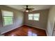 Bedroom with gleaming hardwood floors and natural light streaming through the windows at 503 Roy Huie Rd, Riverdale, GA 30274