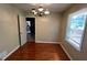 Cozy dining room with hardwood flooring, chandelier lighting, and a large window at 503 Roy Huie Rd, Riverdale, GA 30274