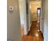 Open hallway showcasing hardwood floors, doorways to rooms, and a glimpse of the front door at 503 Roy Huie Rd, Riverdale, GA 30274